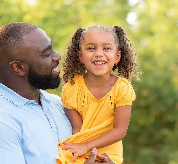 Dad Holding Daughter Outdoors (1)