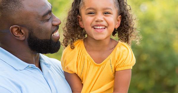 Dad Holding Daughter Outdoors (1)