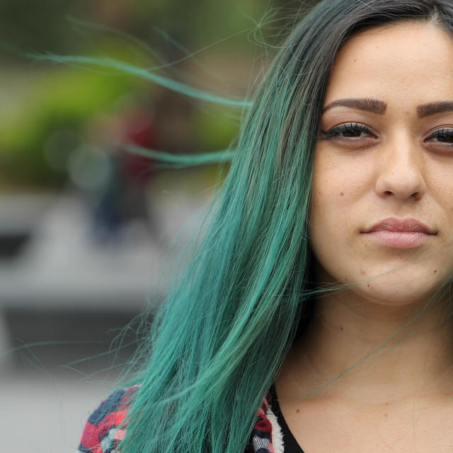 Woman With Black To Green Dip Dyed Hair