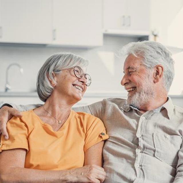 Older Couple Sat On The Sofa