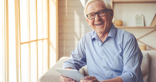 Older Man Happy At Home With Ipad