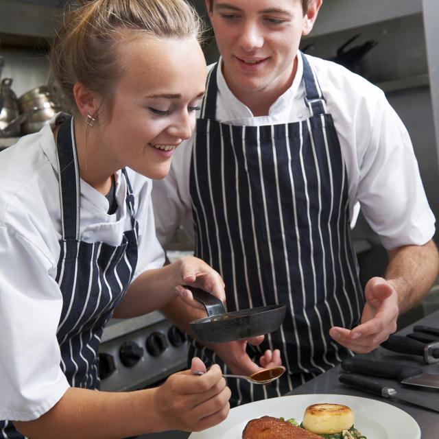 Younger Girl And Boy Making Food And Tasting It