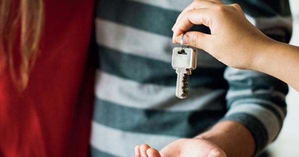 Young Couple Being Handed A Key